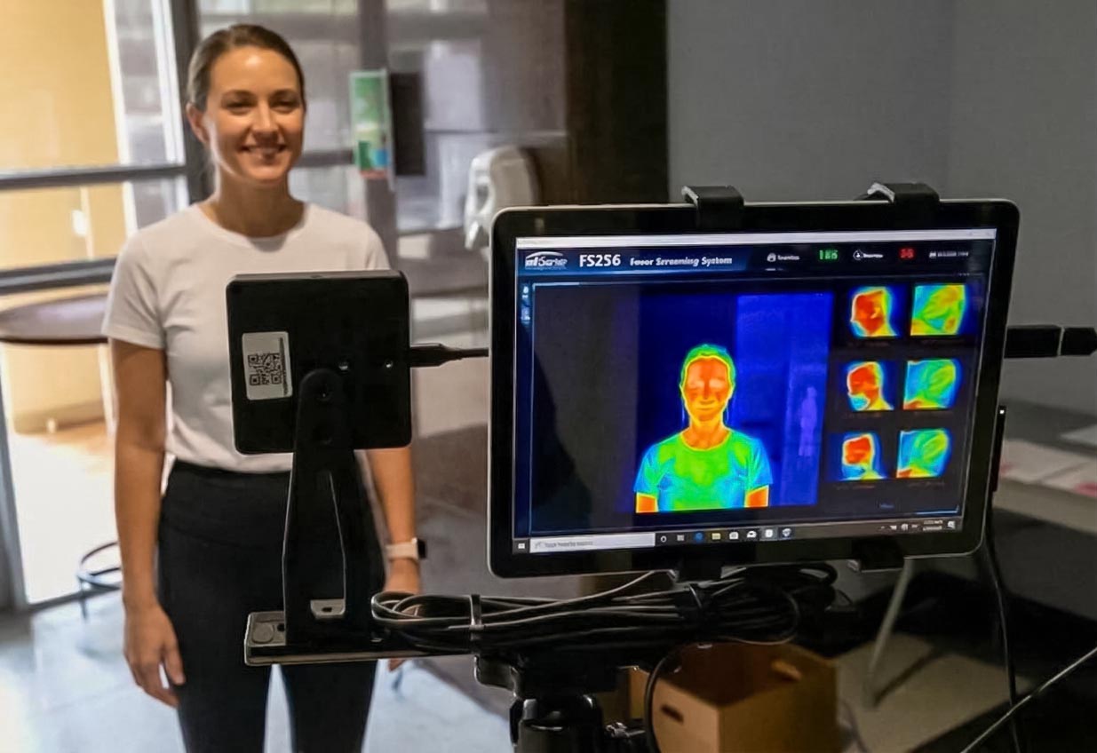 A woman receiving a wellness screening with the BioScan 360 device at SILA Miami in Upper Buena Vista, featuring advanced health metrics and body scan technology.