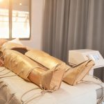 Person lying in a lymphatic drainage suit during a detox session at Sila Miami, FL.