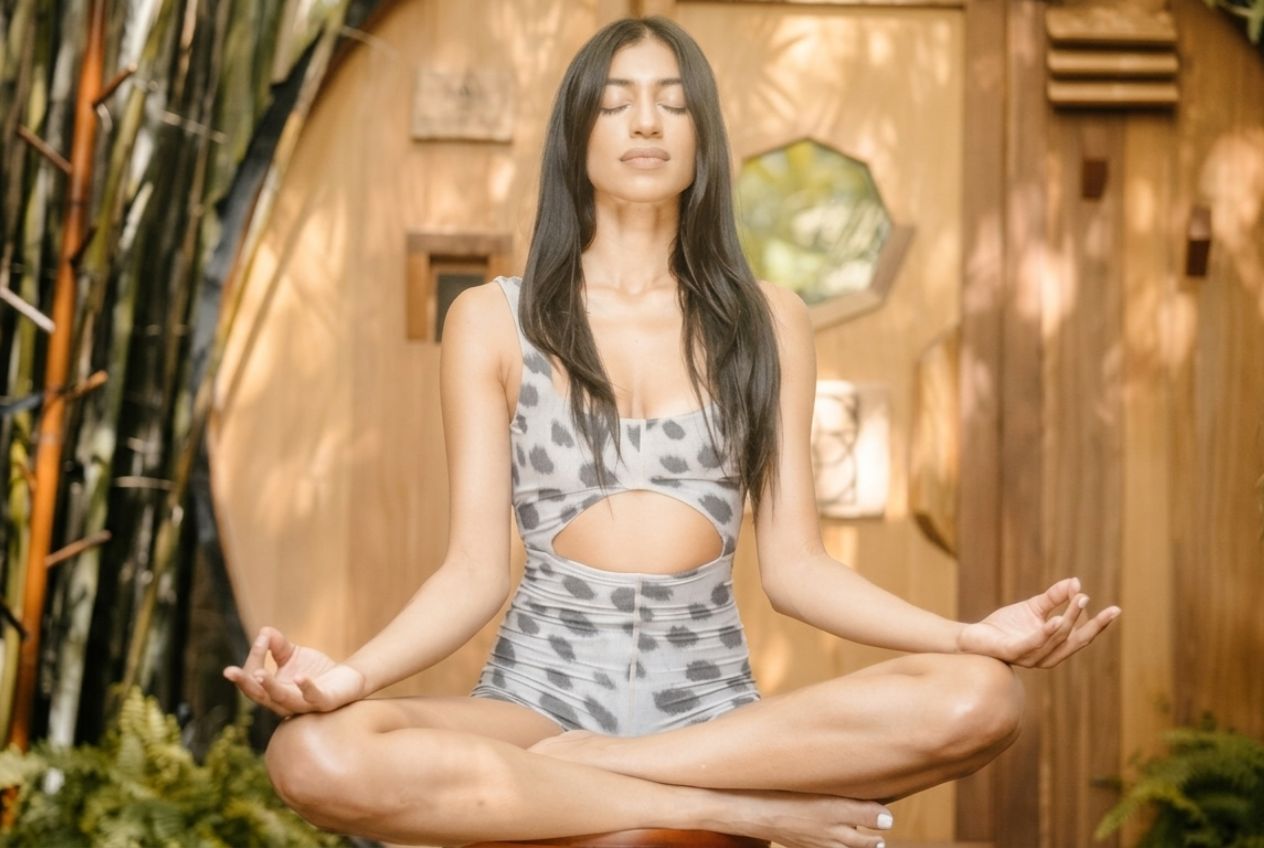 Woman practicing a mindful breathing technique for stress and anxiety in a calm seated meditation at SILA Miami in Miami, FL